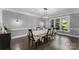 Formal dining room featuring hardwood floors, wainscoting, a large window, and a chandelier at 3916 2Nd Street Nw Dr, Hickory, NC 28601