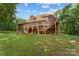 The back of the home features a deck and a ground-level patio with lush greenery surrounding the property at 3916 2Nd Street Nw Dr, Hickory, NC 28601