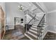 Grand two-story foyer with staircase, chandelier, dark hardwood floors, and decorative iron railings at 3916 2Nd Street Nw Dr, Hickory, NC 28601