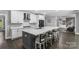 Modern kitchen showcases white cabinets, a large island, dark hardware, and stainless steel appliances at 3916 2Nd Street Nw Dr, Hickory, NC 28601