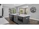 Modern kitchen boasts a large central island, dark cabinetry, and stainless steel appliances at 3916 2Nd Street Nw Dr, Hickory, NC 28601