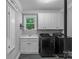 Functional laundry room with modern washer/dryer units, sink and window for convenience and natural light at 3916 2Nd Street Nw Dr, Hickory, NC 28601