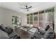 Inviting screened porch with comfortable seating, ceiling fan, and access to an outdoor deck at 3916 2Nd Street Nw Dr, Hickory, NC 28601