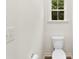 Bathroom shows a toilet, sink and window at 529 N Central Ave, Locust, NC 28097
