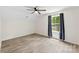 Bright bedroom with a ceiling fan and a large window with tree views at 529 N Central Ave, Locust, NC 28097