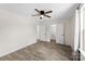 Bright bedroom with light wood flooring, ceiling fan and a closet with an open door at 529 N Central Ave, Locust, NC 28097