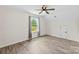 Empty bedroom with laminate floors, a ceiling fan and a window with tree views at 529 N Central Ave, Locust, NC 28097