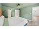 Bedroom with a ceiling fan, green walls and white doors to the bathroom and closet at 529 N Central Ave, Locust, NC 28097
