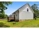 A side angle exterior view of the house featuring a raised wooden deck at 529 N Central Ave, Locust, NC 28097
