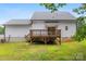Backyard with raised wooden deck and house with white siding at 529 N Central Ave, Locust, NC 28097
