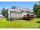 Exterior view of the backyard side of the house with wooden deck at 529 N Central Ave, Locust, NC 28097