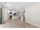 A well-lit kitchen and dining area with white cabinets, modern appliances, and sleek, durable luxury vinyl flooring at 529 N Central Ave, Locust, NC 28097