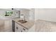 Kitchen island boasting granite countertops, stainless steel sink, and modern white cabinetry in an open living space at 529 N Central Ave, Locust, NC 28097