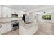 Modern kitchen features granite countertops, stainless steel appliances, and flows seamlessly into the adjacent living area at 529 N Central Ave, Locust, NC 28097