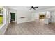 Bright open-concept living area showcasing modern luxury vinyl flooring, neutral walls, and lots of natural light at 529 N Central Ave, Locust, NC 28097