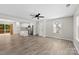 Bright living room with luxury vinyl flooring, and the kitchen offers white cabinets and stainless steel appliances at 529 N Central Ave, Locust, NC 28097