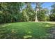 Expansive backyard with lush green grass and mature trees, offering a serene and private outdoor space at 617 Rock Hill Church Rd, Matthews, NC 28104