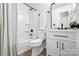 Clean bathroom with black fixtures, white vanity, and shower with curtain rod at 617 Rock Hill Church Rd, Matthews, NC 28104