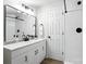 Bright bathroom features white shaker cabinets, a modern mirror, and a tiled shower at 617 Rock Hill Church Rd, Matthews, NC 28104