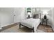 Bedroom features natural light, wood floors, two side tables, and neutral decor at 617 Rock Hill Church Rd, Matthews, NC 28104