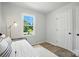 Bedroom featuring hardwood floors, a window with a view, and an iron bed frame at 617 Rock Hill Church Rd, Matthews, NC 28104