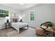 Bedroom features natural light, wood floors, and a chair in the corner at 617 Rock Hill Church Rd, Matthews, NC 28104