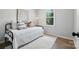Bedroom with sleek decor, a black iron bed frame, and a modern rug at 617 Rock Hill Church Rd, Matthews, NC 28104