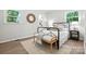 Bright bedroom features natural light, wood floors, and a decorative bench at the end of the bed at 617 Rock Hill Church Rd, Matthews, NC 28104