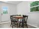 Cozy dining area features wood table, seating for four, and view of backyard at 617 Rock Hill Church Rd, Matthews, NC 28104