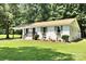 Well-maintained home featuring a lush green lawn, charming shutters, and decorative flower boxes at 617 Rock Hill Church Rd, Matthews, NC 28104
