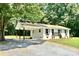 Charming single-story home with a carport, featuring a brick facade and complemented by mature trees at 617 Rock Hill Church Rd, Matthews, NC 28104