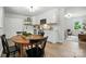 Open-concept kitchen with white cabinets, modern appliances, and an adjacent dining area at 617 Rock Hill Church Rd, Matthews, NC 28104
