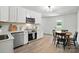 Modern kitchen featuring stainless steel appliances, white cabinetry, and a cozy breakfast nook at 617 Rock Hill Church Rd, Matthews, NC 28104