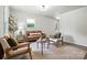 Bright living room with neutral tones, modern furniture, and ample natural light at 617 Rock Hill Church Rd, Matthews, NC 28104