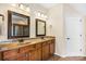 Bathroom with double vanity, framed mirrors, tiled floor, and traditional lighting fixtures at 646 Quicksilver Trl # 183, Fort Mill, SC 29708