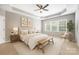 Bedroom featuring a tray ceiling, ceiling fan, and a bench in front of the bed at 646 Quicksilver Trl # 183, Fort Mill, SC 29708