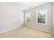 Bedroom with neutral carpet and paint, and two windows with bright natural light at 646 Quicksilver Trl # 183, Fort Mill, SC 29708