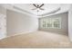 Bedroom with a tray ceiling, ceiling fan, carpet, and a window at 646 Quicksilver Trl # 183, Fort Mill, SC 29708