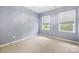 Bedroom with plush carpet and two bright windows, illuminated by a modern ceiling fan at 646 Quicksilver Trl # 183, Fort Mill, SC 29708