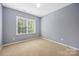 Bedroom with neutral carpet, a large window, and a modern ceiling light at 646 Quicksilver Trl # 183, Fort Mill, SC 29708