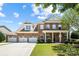 Stunning two-story brick home with a three car garage, beautifully landscaped yard and inviting front porch at 646 Quicksilver Trl # 183, Fort Mill, SC 29708