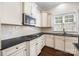 Kitchen with white cabinets, stainless microwave, gas range, and dark countertops at 646 Quicksilver Trl # 183, Fort Mill, SC 29708