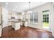 Modern kitchen featuring white cabinetry, an island, stainless steel appliances, and hardwood floors at 646 Quicksilver Trl # 183, Fort Mill, SC 29708