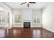 Spacious living room with a black fireplace, hardwood floors, and two large windows for abundant natural light at 646 Quicksilver Trl # 183, Fort Mill, SC 29708