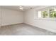 Simple bedroom with a ceiling fan and a large window at 6602 Gaywind Dr, Charlotte, NC 28226
