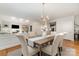 Open dining area featuring a chandelier, with a view into living room at 6602 Gaywind Dr, Charlotte, NC 28226