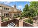 Exterior view of home featuring a brick wall, manicured landscaping, and mature shade trees at 6602 Gaywind Dr, Charlotte, NC 28226