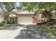 Two-story home with a two-car garage, manicured landscaping, and brick accents at 6602 Gaywind Dr, Charlotte, NC 28226