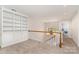 Hallway featuring built-in bookshelves and a view of the backyard through an adjacent window at 6602 Gaywind Dr, Charlotte, NC 28226