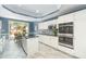 Bright kitchen with white cabinetry, stainless steel appliances, a center island, and access to outdoor seating at 6602 Gaywind Dr, Charlotte, NC 28226